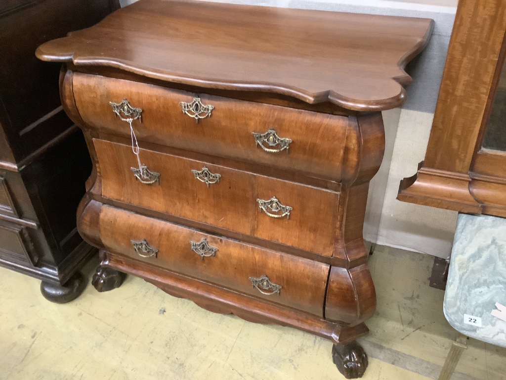 A 19th century and later Dutch mahogany bombe chest of three long drawers, raised on claw and ball feet